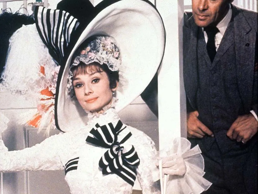 Eliza Doolittle's 'Makeover' in My Fair Lady (1965). Eliza wears a white and black ensemble with a frilly dress and hat