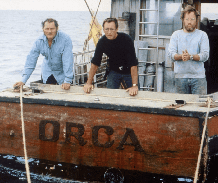 Quint, Brody, & Hooper on board the 'Orca' as they look "excitedly" ahead of the challenge in Jaws (1975) - Filmotomy